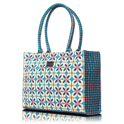 Retro style patterned handbag with pink flower accents and tan. brand logo patch.