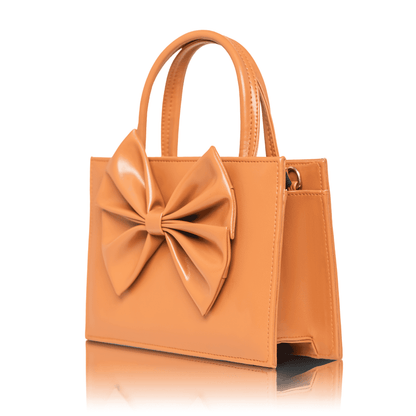 Coquette style camel brown mini bag with oversized bow detail and structured design.