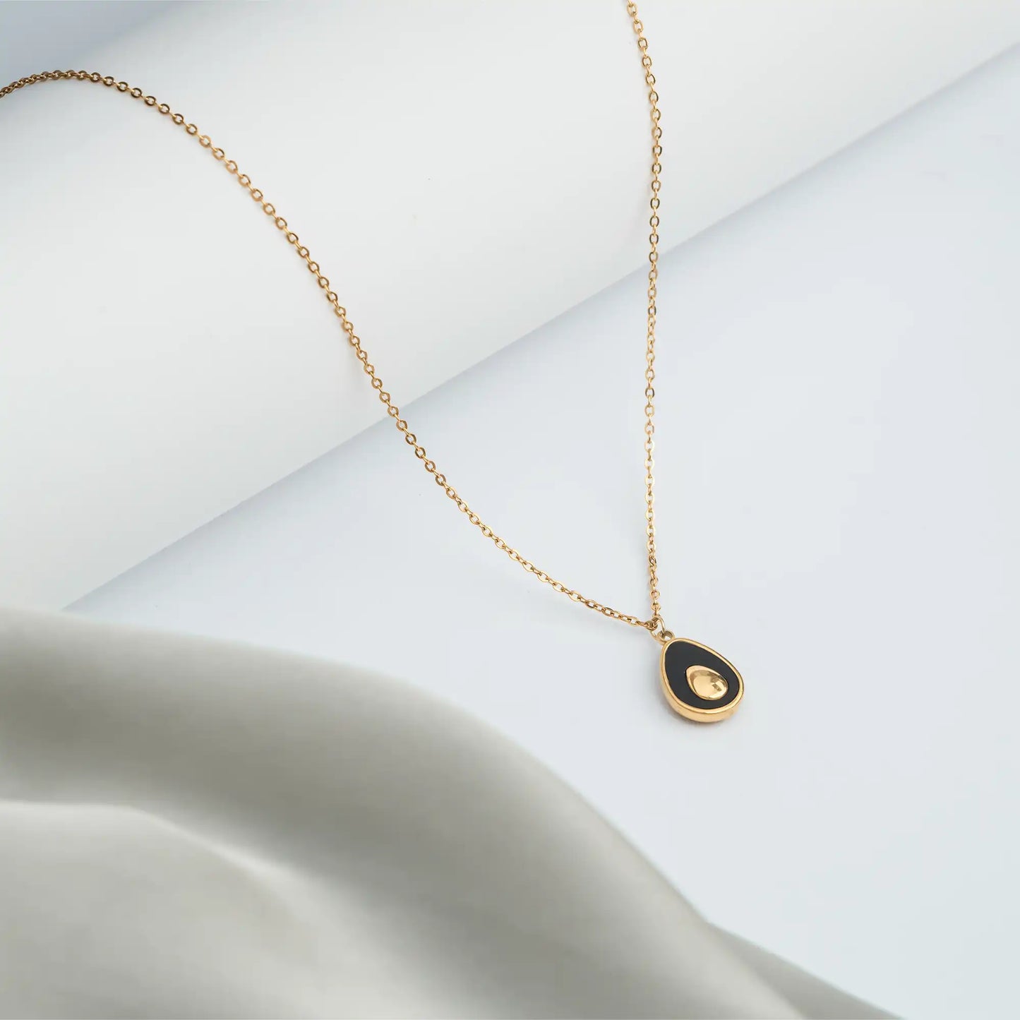 golden necklace with black teardrop pendant for women