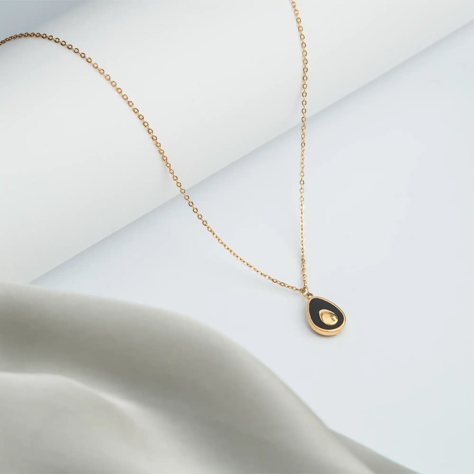golden necklace with black teardrop pendant for women