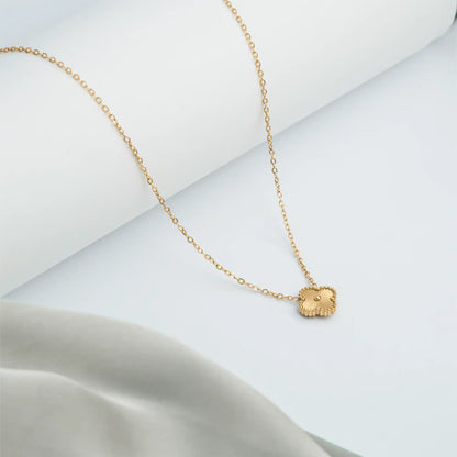 gold necklace with a small clover pendant