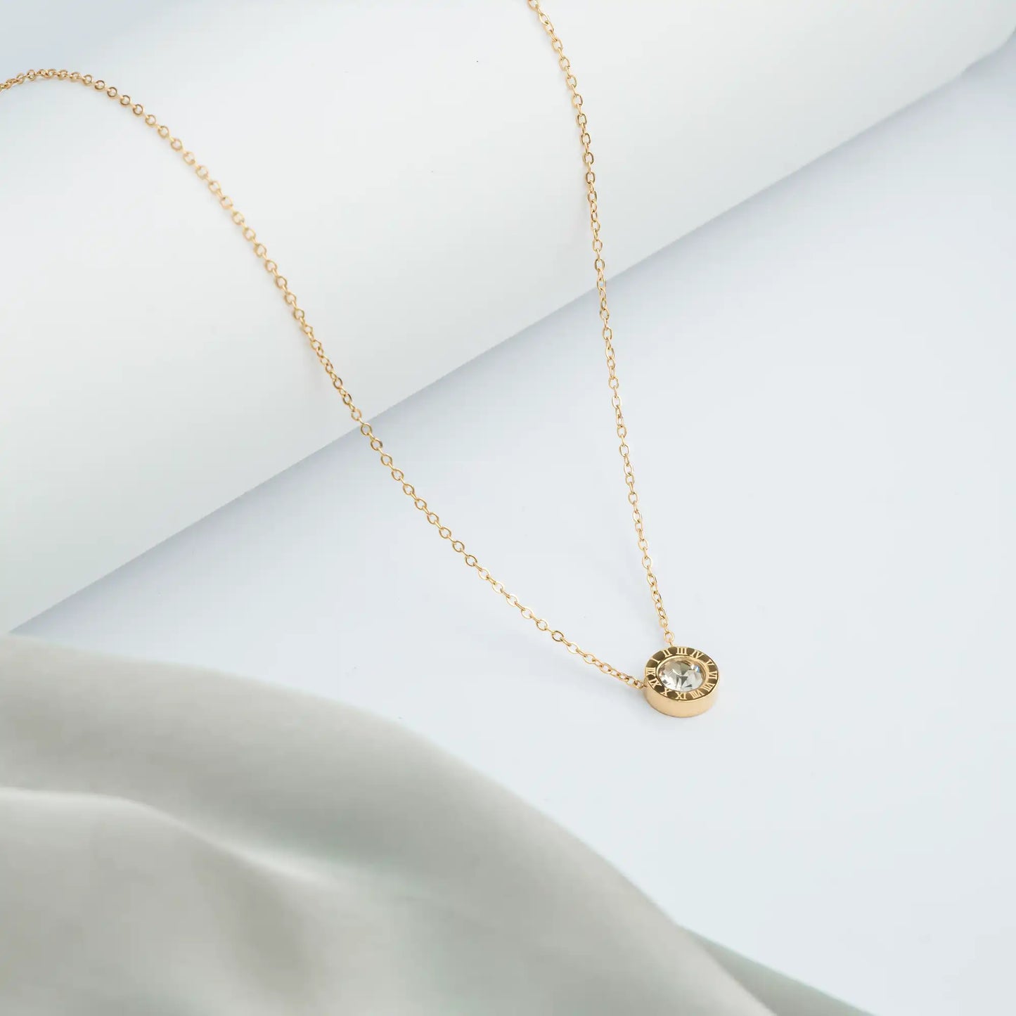 golden necklace with a small pendant and delicate chain 