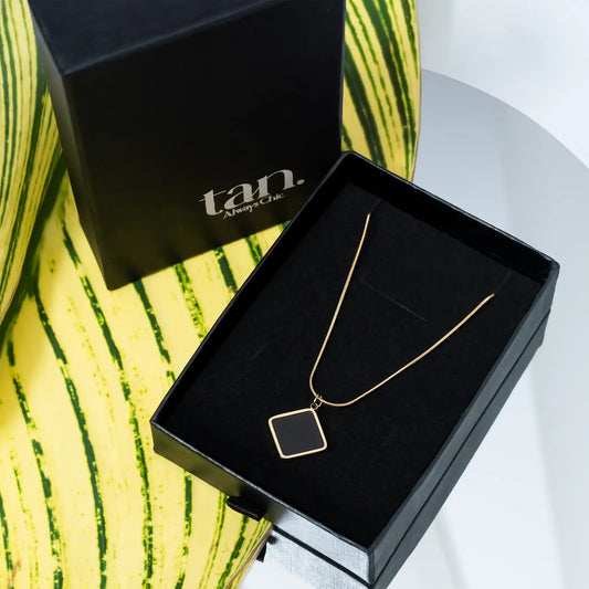 delicate pendant necklace in black gift box by tan.