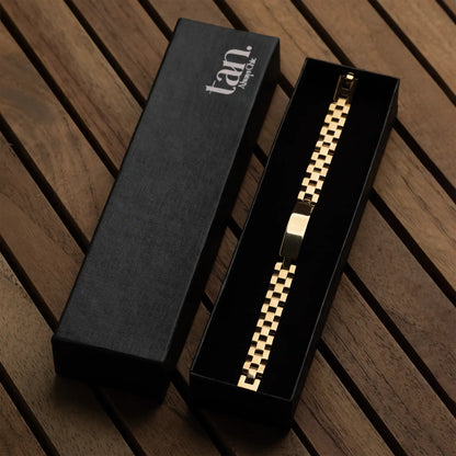 Men's golden stainless steel link bracelet with polished ID bar by tan.