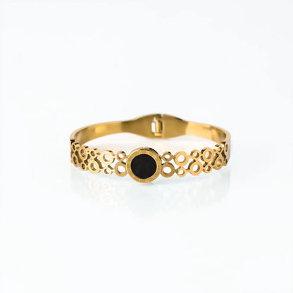 golden cuff for women with black dial and roman numeral detail