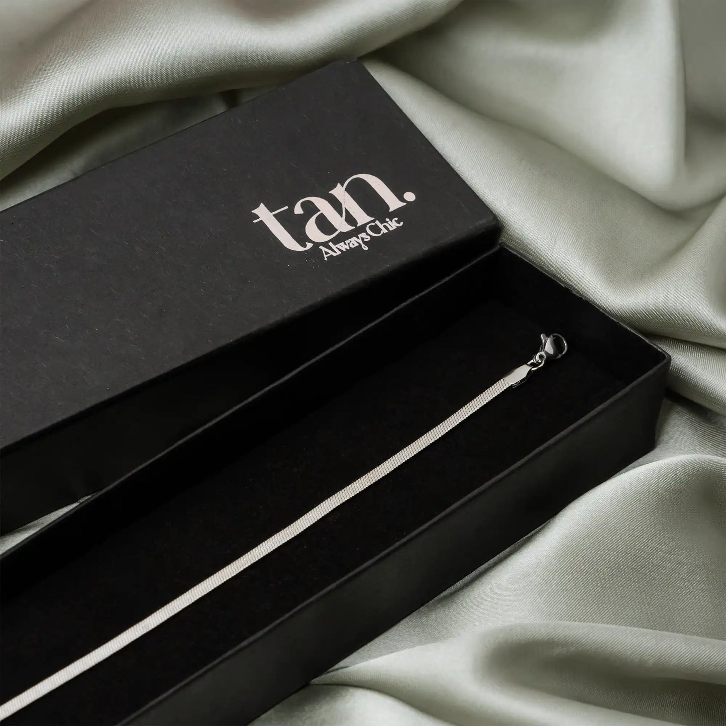 minimal anklet by tan in premium black packaging