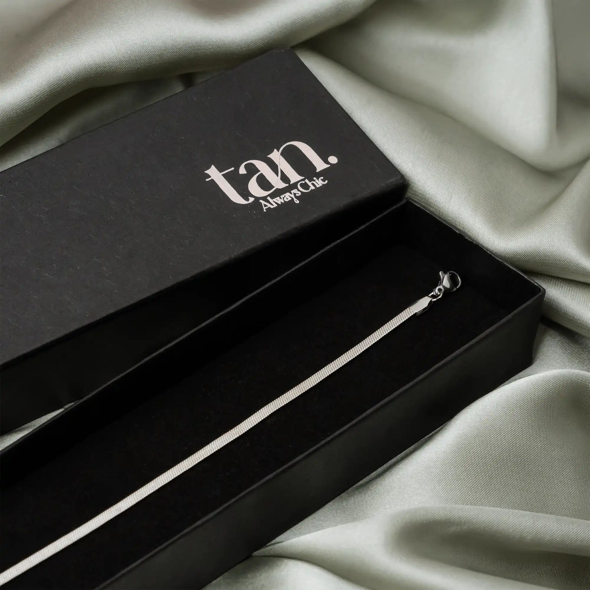 minimal anklet by tan in premium black packaging