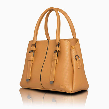 Ochre yellow top-handle ladies handbag with decorative buckle straps and a structured silhouette by tan.
